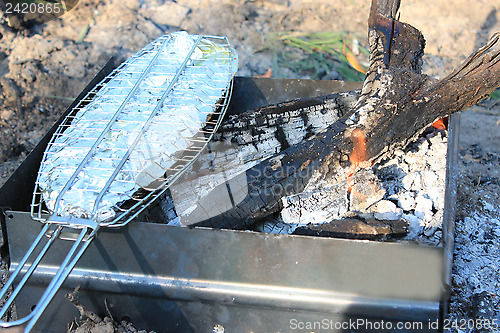 Image of Dish from fried fish cooked on fire