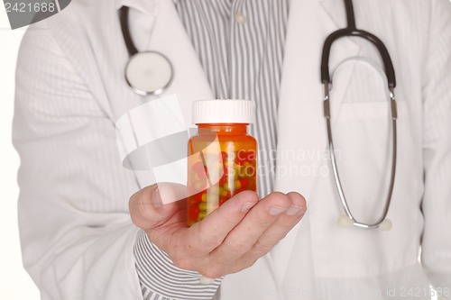 Image of Doctor With Medication in Prescription Bottles