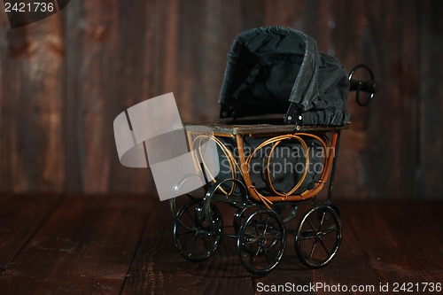 Image of Baby Cradle on Grunge Wooden Background