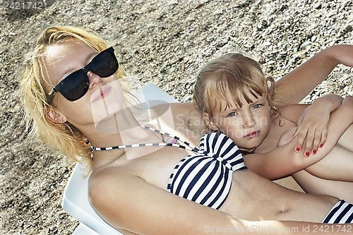 Image of Sister girls resting on the beach