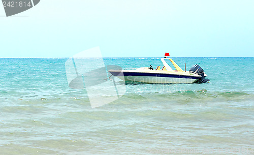 Image of A pleasure boat in the coastal waters near the beach.