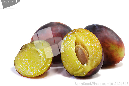 Image of Large ripe plums on a white background.