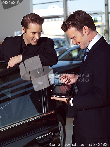 Image of young business men out side of office