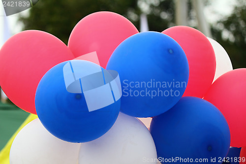 Image of Red, blue, white rubber balloons, filled with gas.