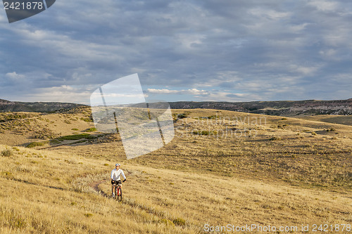 Image of moutain biking in a rolling prairie