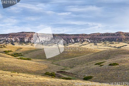 Image of rolling prairie and cliff