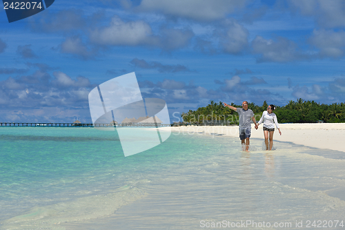 Image of happy young couple have fun on beach