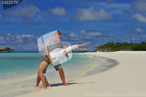 Image of happy young couple have fun on beach