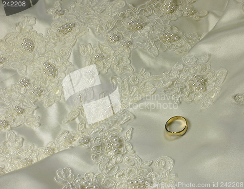 Image of bridal gown details and wedding ring