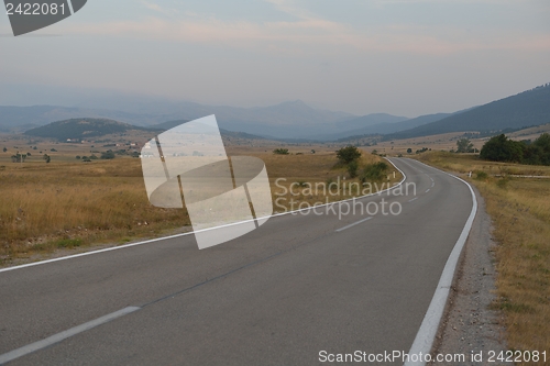 Image of road through the green field