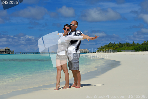 Image of happy young couple have fun on beach