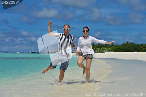Image of happy young couple have fun on beach