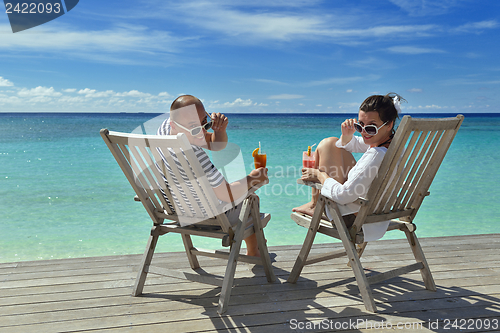 Image of happy young couple relax and take fresh drink
