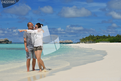 Image of happy young couple have fun on beach