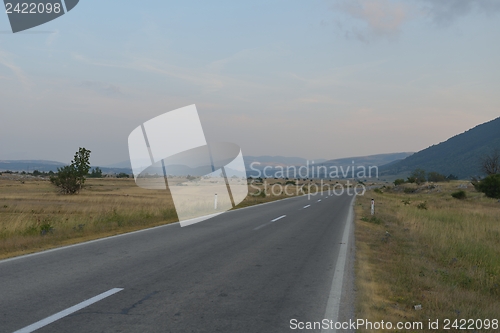 Image of road through the green field