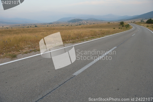 Image of road through the green field