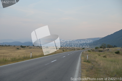 Image of road through the green field