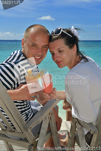 Image of happy young couple relax and take fresh drink