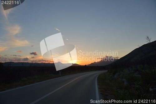 Image of road through the green field