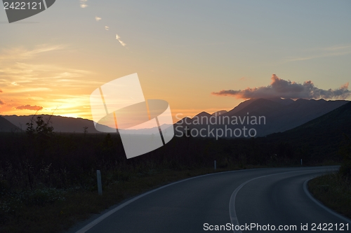 Image of road through the green field