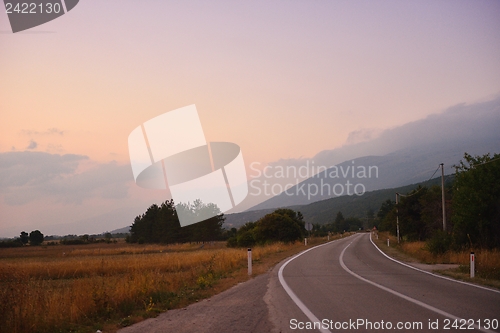 Image of road through the green field