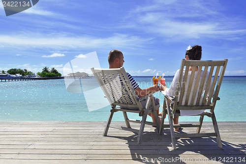 Image of happy young couple relax and take fresh drink