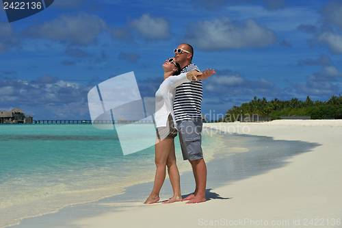 Image of happy young couple have fun on beach