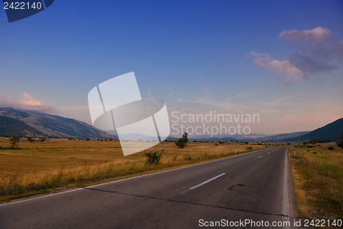 Image of road through the green field