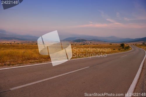 Image of road through the green field