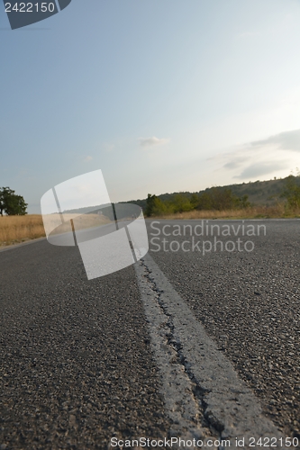 Image of road through the green field