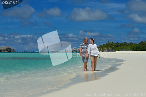 Image of happy young couple have fun on beach