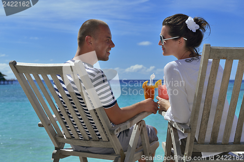 Image of happy young couple relax and take fresh drink