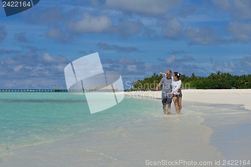 Image of happy young couple have fun on beach