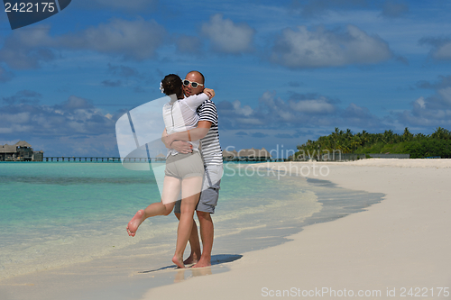 Image of happy young couple have fun on beach