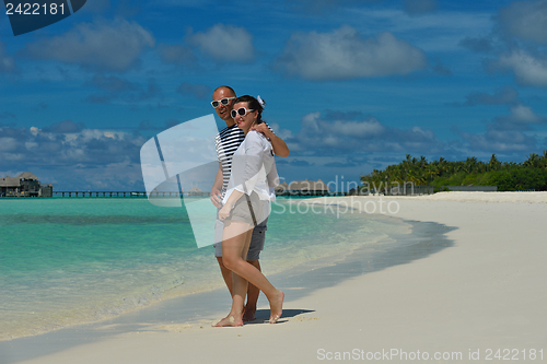 Image of happy young couple have fun on beach