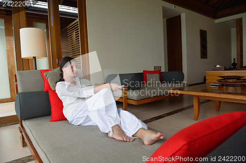 Image of happy young woman relax at home on sofa