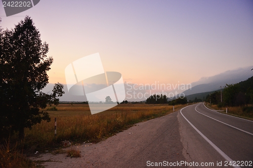 Image of road through the green field