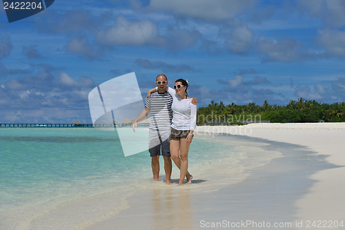 Image of happy young couple have fun on beach