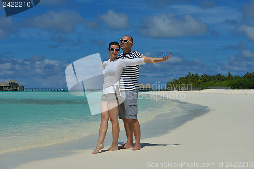 Image of happy young couple have fun on beach