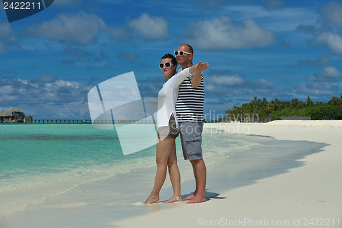 Image of happy young couple have fun on beach