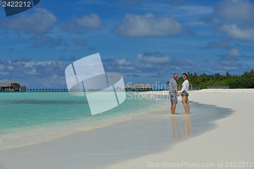 Image of happy young couple have fun on beach