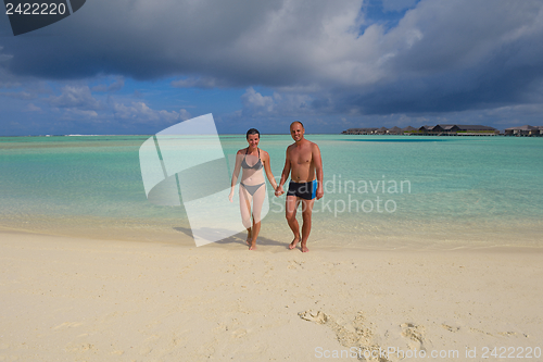 Image of happy young couple have fun on beach