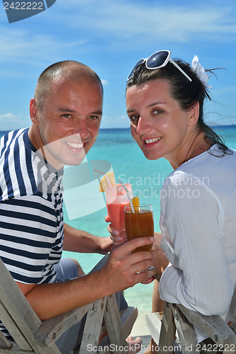 Image of happy young couple relax and take fresh drink