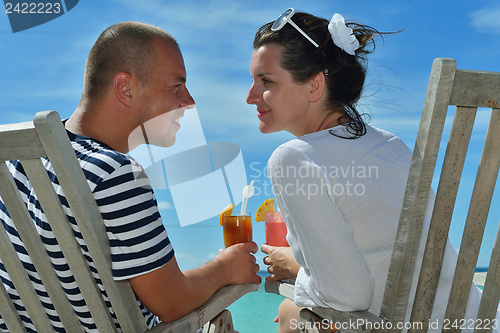 Image of happy young couple relax and take fresh drink