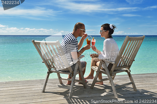 Image of happy young couple relax and take fresh drink