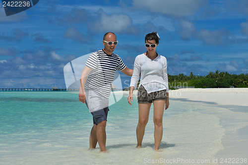 Image of happy young couple have fun on beach