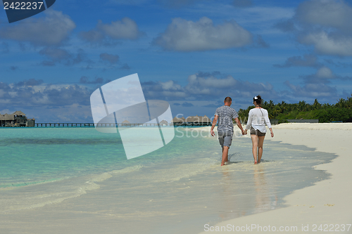 Image of happy young couple have fun on beach