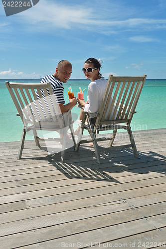 Image of happy young couple relax and take fresh drink