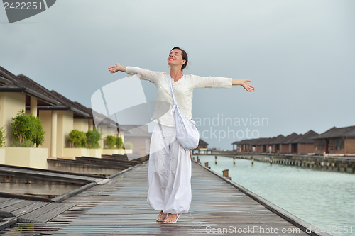 Image of young woman relax on cloudy summer day