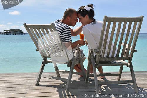 Image of happy young couple relax and take fresh drink